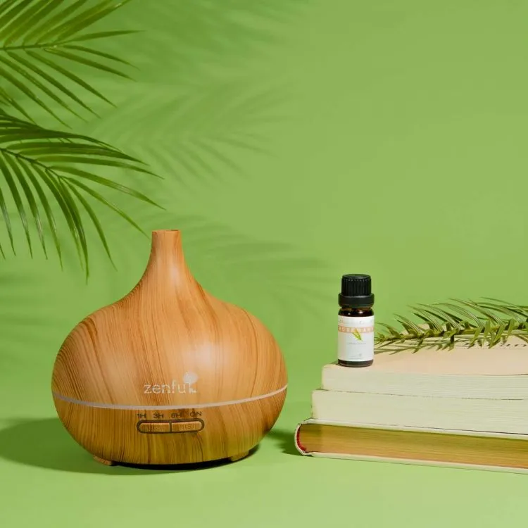 Zenful Rozemarijn etherische olie op boeken met Dewdrop licht hout diffuser
